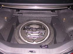 Spare tire kit for 2009 through 2012 Infiniti G37 convertibles image showing mounted spare tire with accessory kit